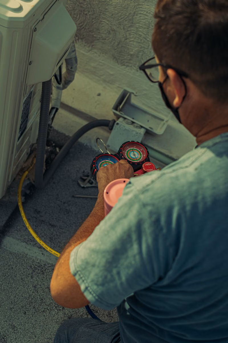 Technician checking furnace readings during service